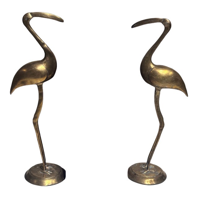 A Pair of Vintage Solid Brass Crane Figurines Standing Gracefully on Round Bases With a Warm, Aged Patina. For Sale