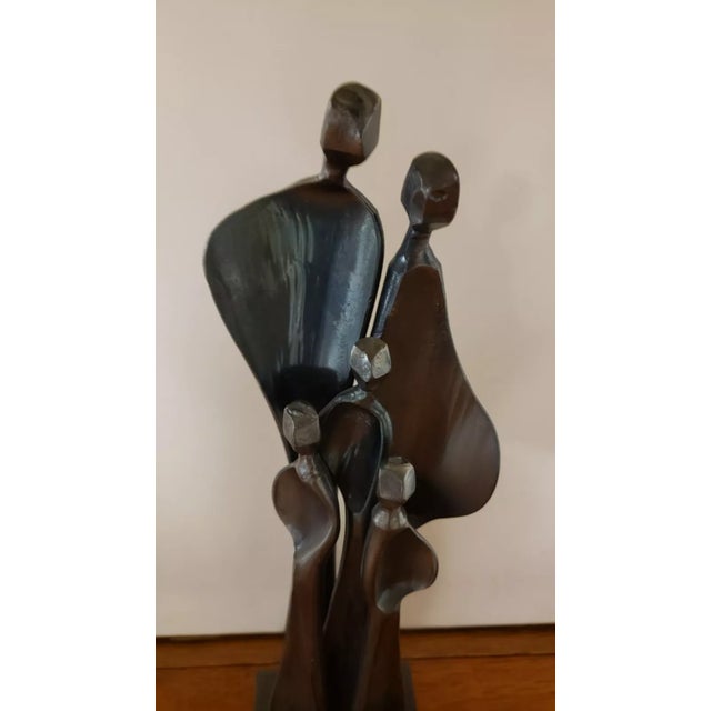 This is a Boris Kramer “Family With Three Children” Steel Sculpture (20th Century). It measures 12 7/8" high and a base of...