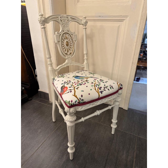 Vintage chair in neoclassical style It impresses with its antique white lacquer finish, fluted legs, and a delicately...