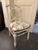 Vintage chair in neoclassical style It impresses with its antique white lacquer finish, fluted legs, and a delicately...