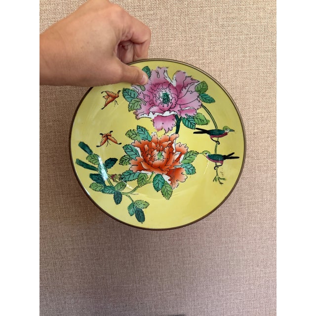 This listing is for a vintage, porcelain bowl in yellow with hand-painted floral details. It is set in brass with a hanger...