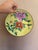 This listing is for a vintage, porcelain bowl in yellow with hand-painted floral details. It is set in brass with a hanger...