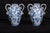 A pair of Neapolitan glazed majolica vases depicting pastoral scenes, dating from the late 19th century. The body is ovoid...