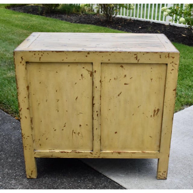 Vintage (1990's) Two Door Cabinet has a Chinese Ming Style. The cabinet has Two Drawers and Two Doors with Metal Hardware...