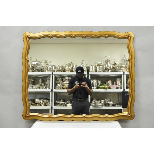 Vintage Hollywood Regency Gold Scalloped Serpentine Wood Frame Dorothy Draper Style Wall Mirror. Circa Mid 20th Century....