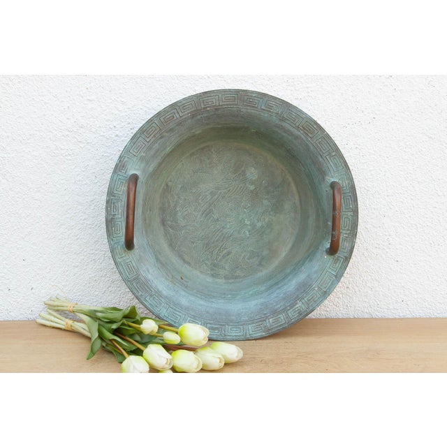 A commanding piece of archaic-style metalwork, this massive bronze basin mimics the ritual water vessels ("Pan") of the...