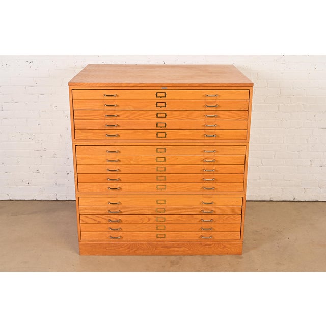 An exceptional vintage Mid-Century Modern or Arts & Crafts style oak 15-drawer architect's blueprint flat file cabinet,...