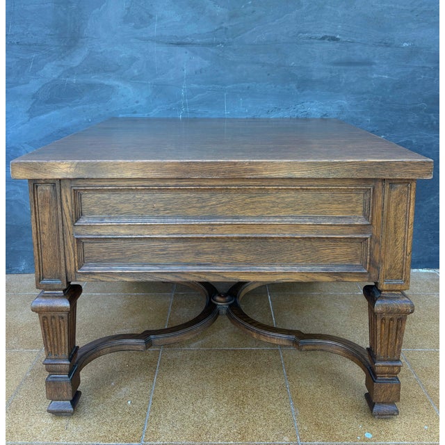 Substantial pair of Spanish classical revival side tables crafted in solid oak, mid-20th century. Each table features two...
