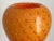 A small vintage Murano art glass vase, with controlled bubble and gold flake on a bright orange background.. No marks....