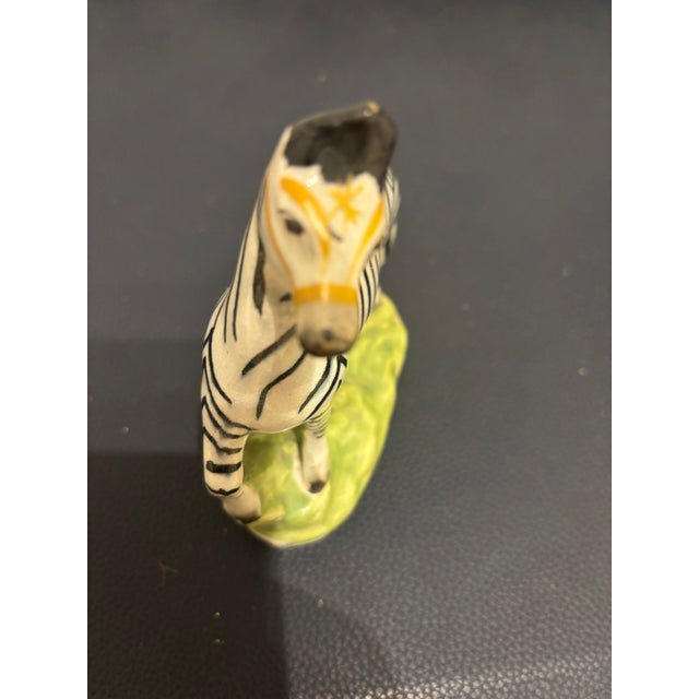 For the Staffordshire collector, a rare early 19th century Staffordshire figure of a Zebra standing on a green mound,...