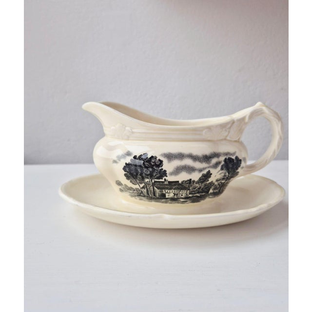 Charming mid-20th-century english transferware gravy boat (sauce boat with attached stand/underplate), crafted in...