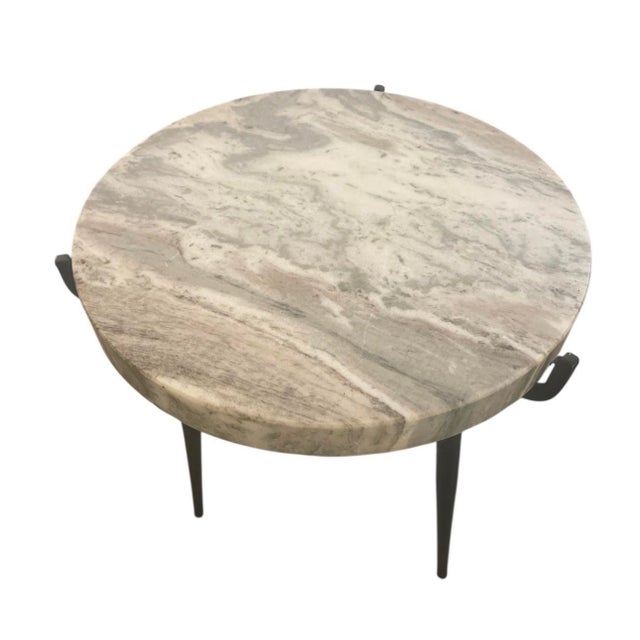 A sophisticated and minimalist accent table. Featuring a thick, solid marble top with natural grey veining, this piece...