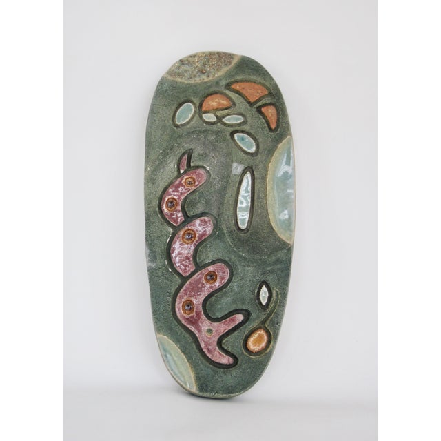 Studio made artwork drawn from organic shapes into decorative form, this spectacular green oval ceramic slab sculpture...