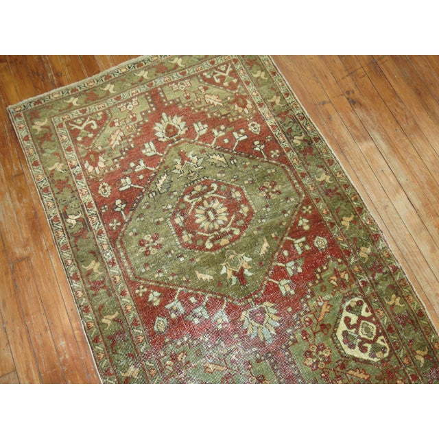 A Decorative Persian Heriz one of a kind antique runner from the early 20th century with rustic colors Measures: 3' x 10'9".