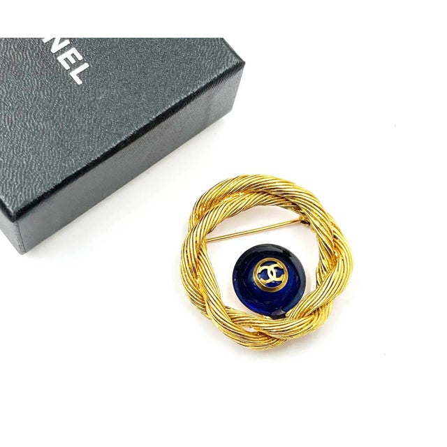 Chanel Vintage Gold Plated CC Blue Stone Rope Wreath Brooch *Marked 94 *Made in France *Comes with the original box – It...