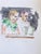 This watercolor piece captures two figures engaged in a moment of concentration, their expressions reflecting a quiet...