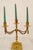 This is a three-arm brass candlestick, also known as a candelabra. It has three candlestick arms, elegantly curving...