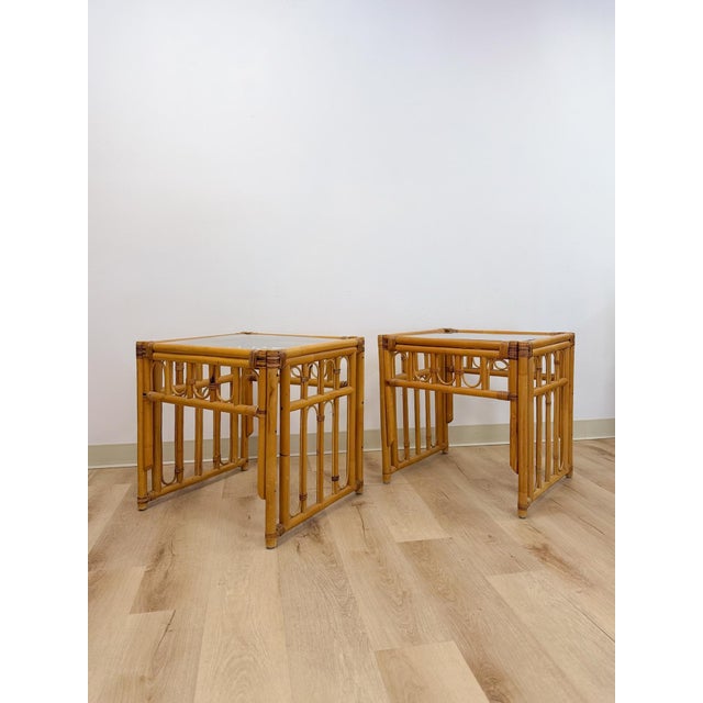 This lovely pair of vintage rattan end tables with arched inlay pattern and glass tops are a warm and beautifully detailed...