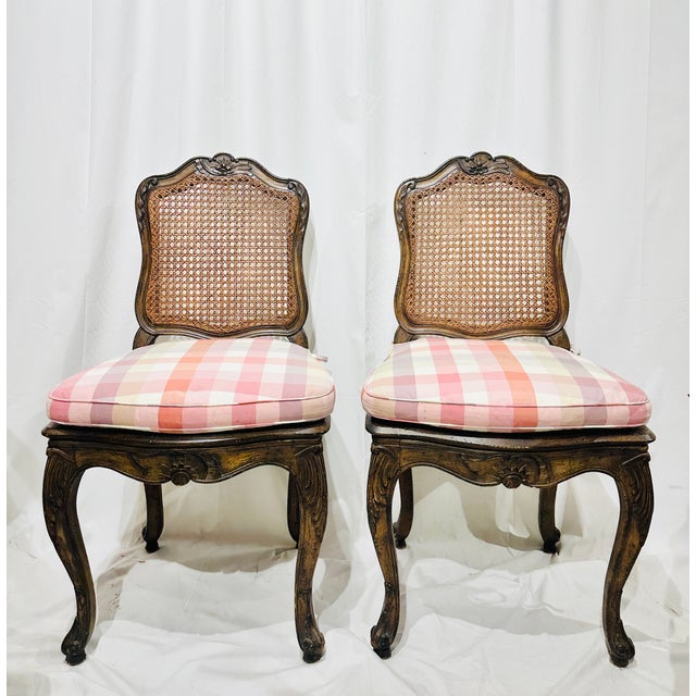 Elegant set of four French Louis XV–style chairs, including two armchairs and two side chairs. Each features a hand-carved...
