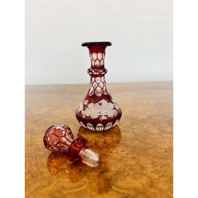 Quality antique Victorian glass spirit perfume bottle and stopper having a red and clear glass body with etched fruiting...
