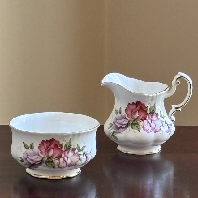 A delightful mid-20th century creamer and open sugar bowl by Paragon Fine Bone China of England. Decorated with romantic...
