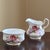 A delightful mid-20th century creamer and open sugar bowl by Paragon Fine Bone China of England. Decorated with romantic...