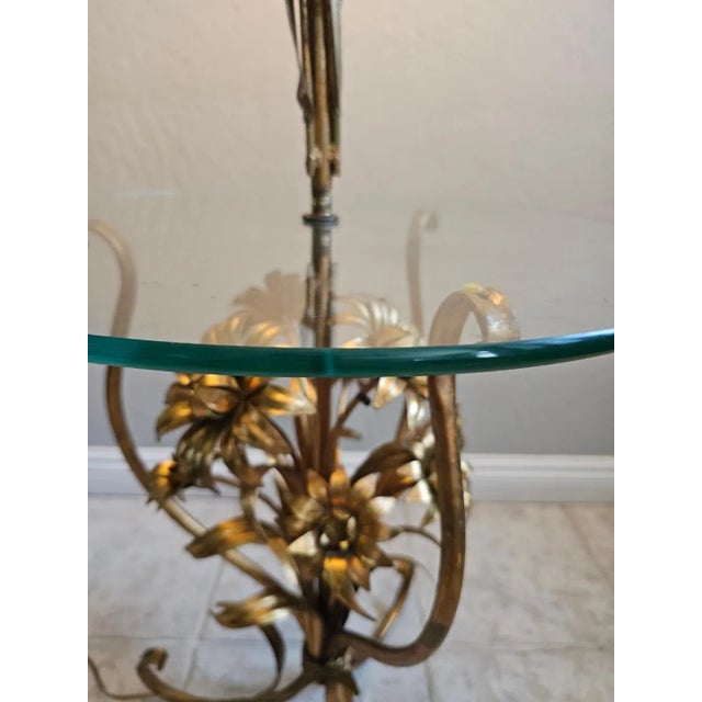 In Superb condition! Mid century Hollywood Regency Gold Gild metal tall floor lamp with a glass round side table. The...