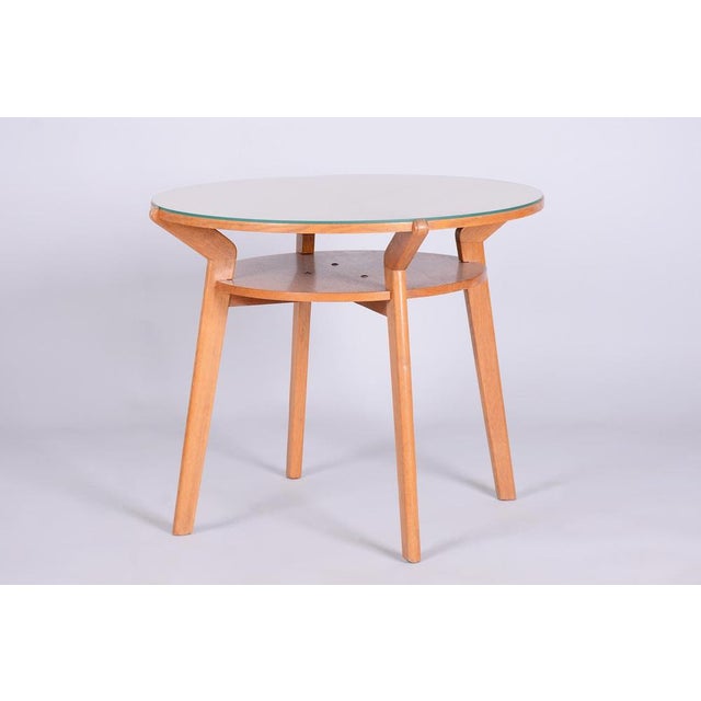 This round coffee table is an elegant representative of Czechoslovak Mid-Century design from the mid-20th century. This...