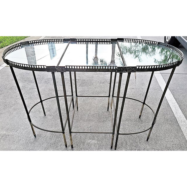 Here's a mid 20th century noclassical tripartite console table in the style of Maison Jansen or Maison Baguès. It features...