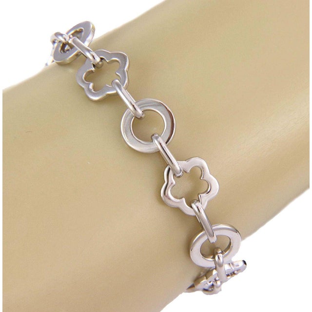 This elegant authentic bracelet is by Chanel from the Camellia collection. It is crafted from 18k white gold with a...