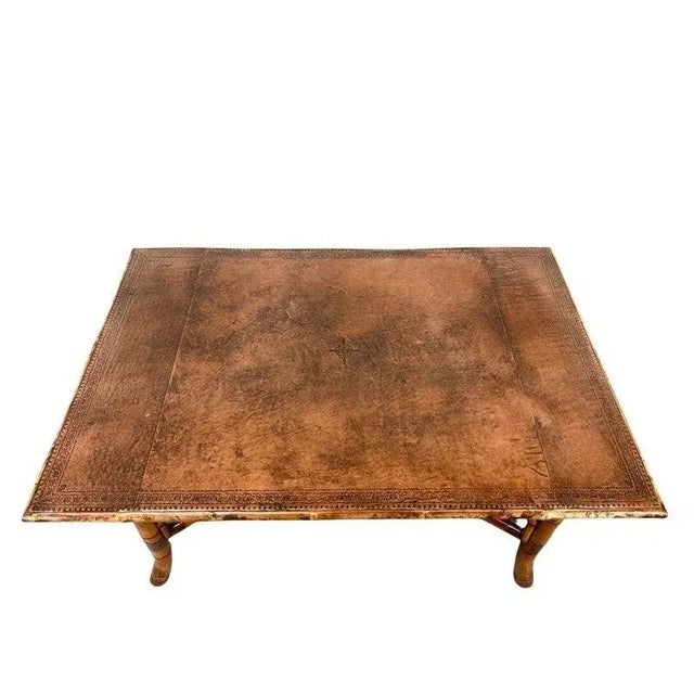 This distinctive rectangular dining table combines rich texture with organic elegance, featuring a tooled leather tabletop...