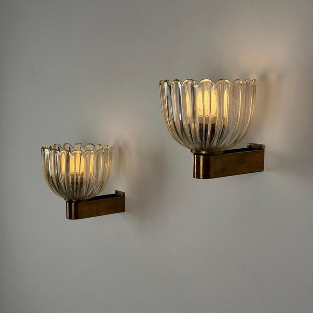 A rare and refined pair of Murano wall sconces by Barovier & Toso, designed by Ercole Barovier, Italy, 1940s. Each sconce...