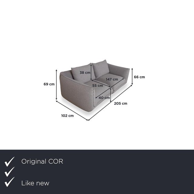 With the cor jalis, you get a two-seater sofa that focuses entirely on soft, rounded shapes. The gray fabric upholstery...