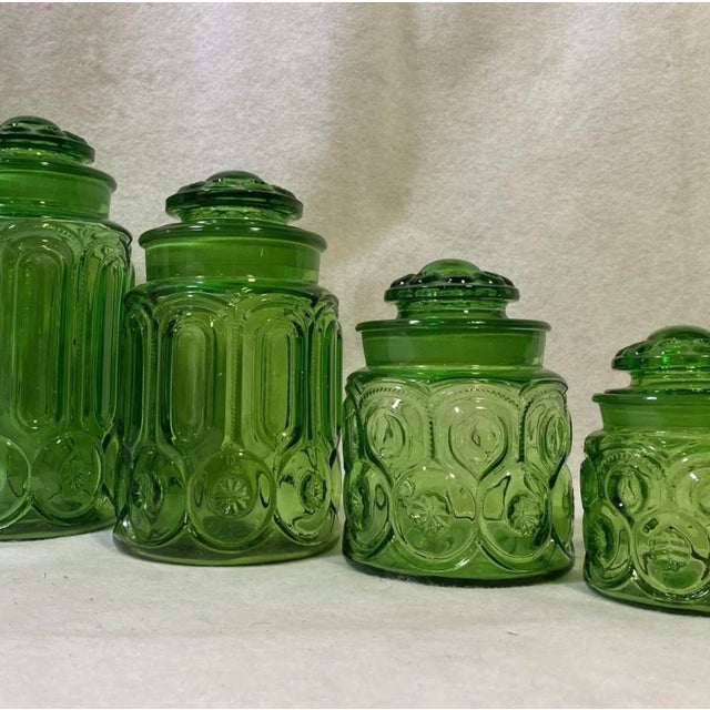 Agreat vintage set of emerald green glass kitchen canister set with a mooon and stars pattern. This s1960's era set has a...