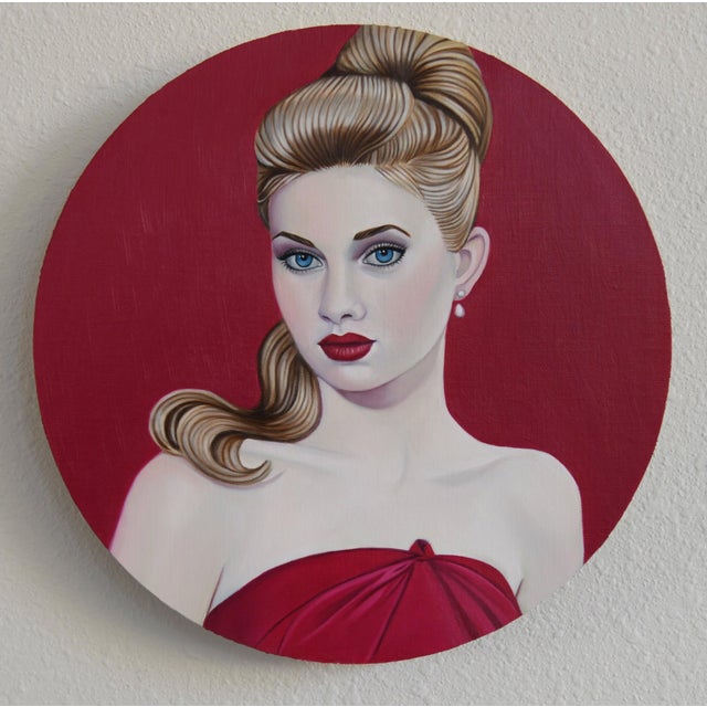 This artwork features a striking portrait of a young woman against a bold crimson backdrop, emphasizing her elegant...