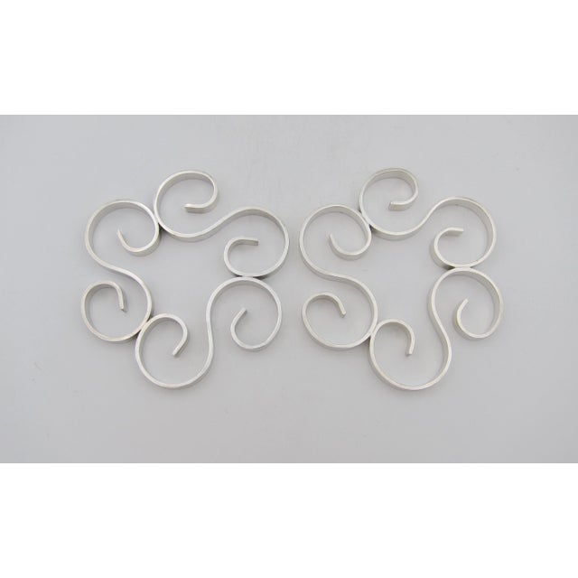 Two French Art Deco trivets from Christofle's Gallia line of cast and silver-plated luxury goods. These stylish vintage...