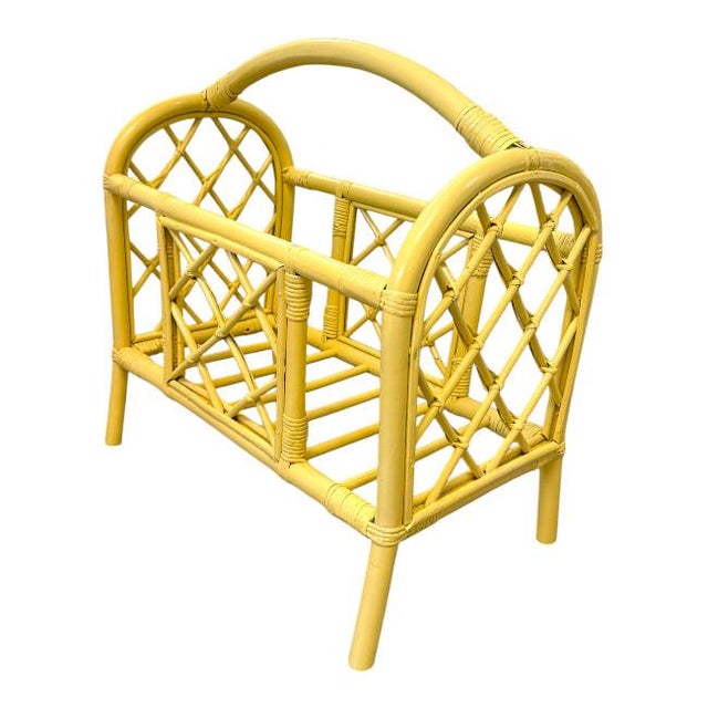 Vintage rattan magazine rack finished in a cheerful lacquered yellow, bringing a playful yet sophisticated touch to any...