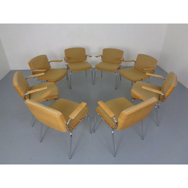 One of eight Danish armchairs by Duba Møbelindustri from the 1960s. The armrests, seat shell, and backrest are made of...