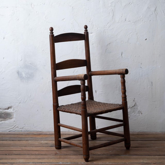 An oak ladderback open armchair from the Rock Hill area of South Carolina, dating to the mid-19th century, with slat back...