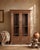 This almirah has a quieter elegance, a shaped apron at its base, carved lower door panels, and brass drop handles that...
