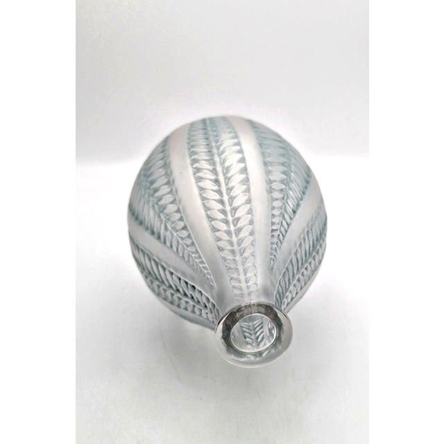 An exquisite Art Deco clear and frosted glass vase, model "Acacia", designed by René Lalique. This fine piece was...