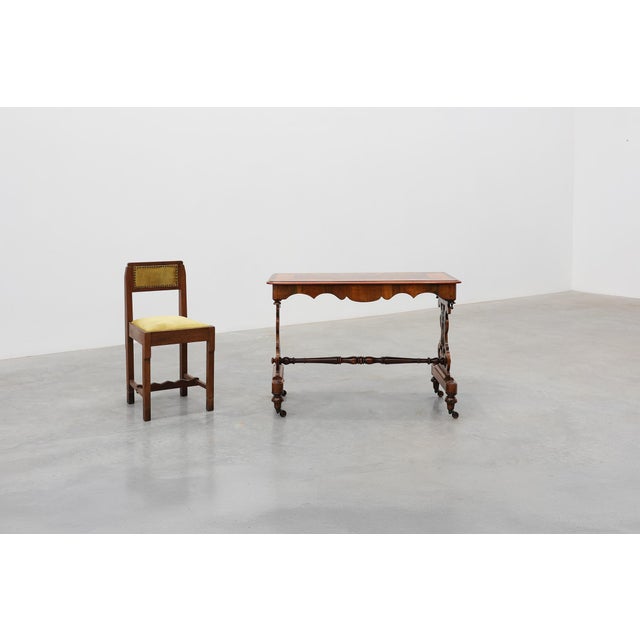 An elegant Victorian side table crafted in walnut and dating to the late 19th century. The rectangular top is richly...
