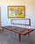 A beautiful example of Danish modern design featuring a sculptural teak frame, tapered legs and exposed metal back...