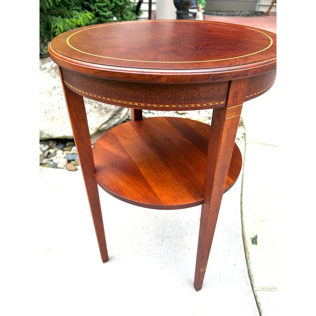 This vintage, mahogany, round end-table was a revival of the Federal style, in the 1950s. It has beautiful inlaid wood...
