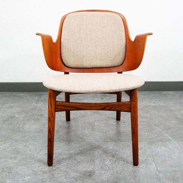 Model 107 armchair designed by Hans Olsen for Bramin Møbler. Chair features a frame of teak with a molded ply back and new...