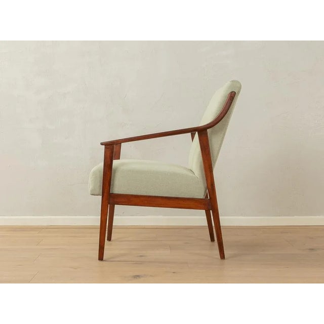 Classic armchair from the 1950s. High-quality frame in dark stained beech. The armchair has its original spring core and...