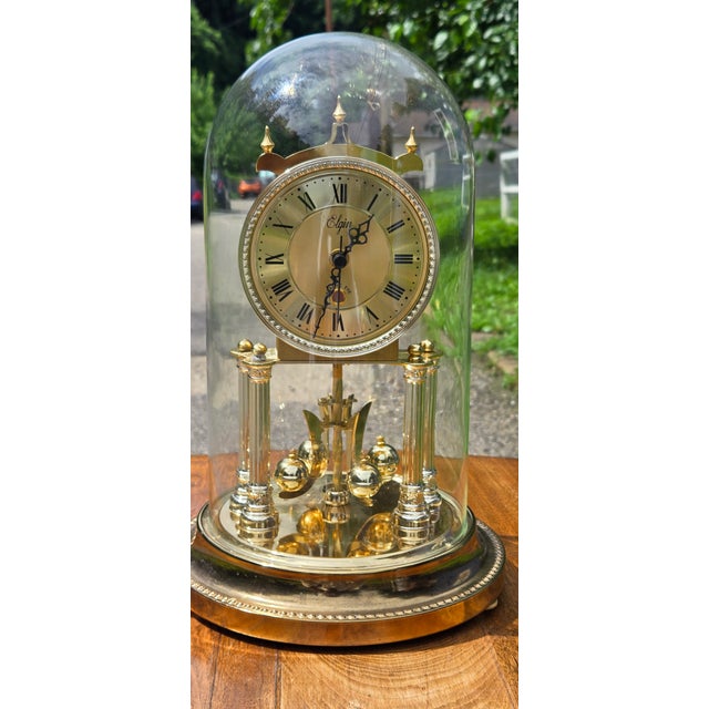 Description: Add timeless elegance to your home with this beautiful vintage Elgin Anniversary Clock, featuring a polished...