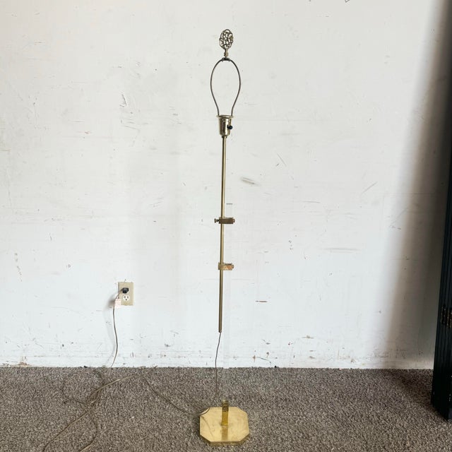 This elegant Regency-style floor lamp features a blend of lucite and gold accents, creating a luxurious and timeless...
