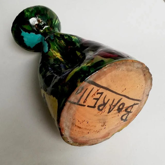 This jug ​​features painted abstract motifs, and abstract faces.