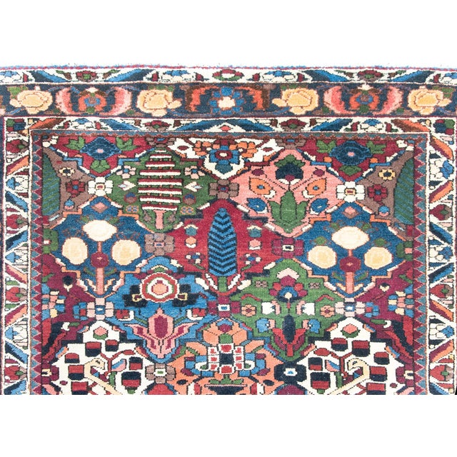 A wonderful early 20th century Persian Bakhtiari rug with a pattern of alternating cypress trees, rose bushes, and myriad...